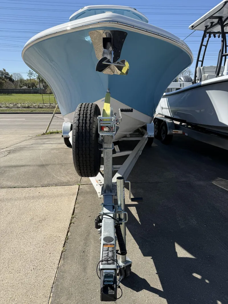 Slide: The Image of 2025 Tidewater 232 CC Adventure boat on trailer, parked outdoors. - 10