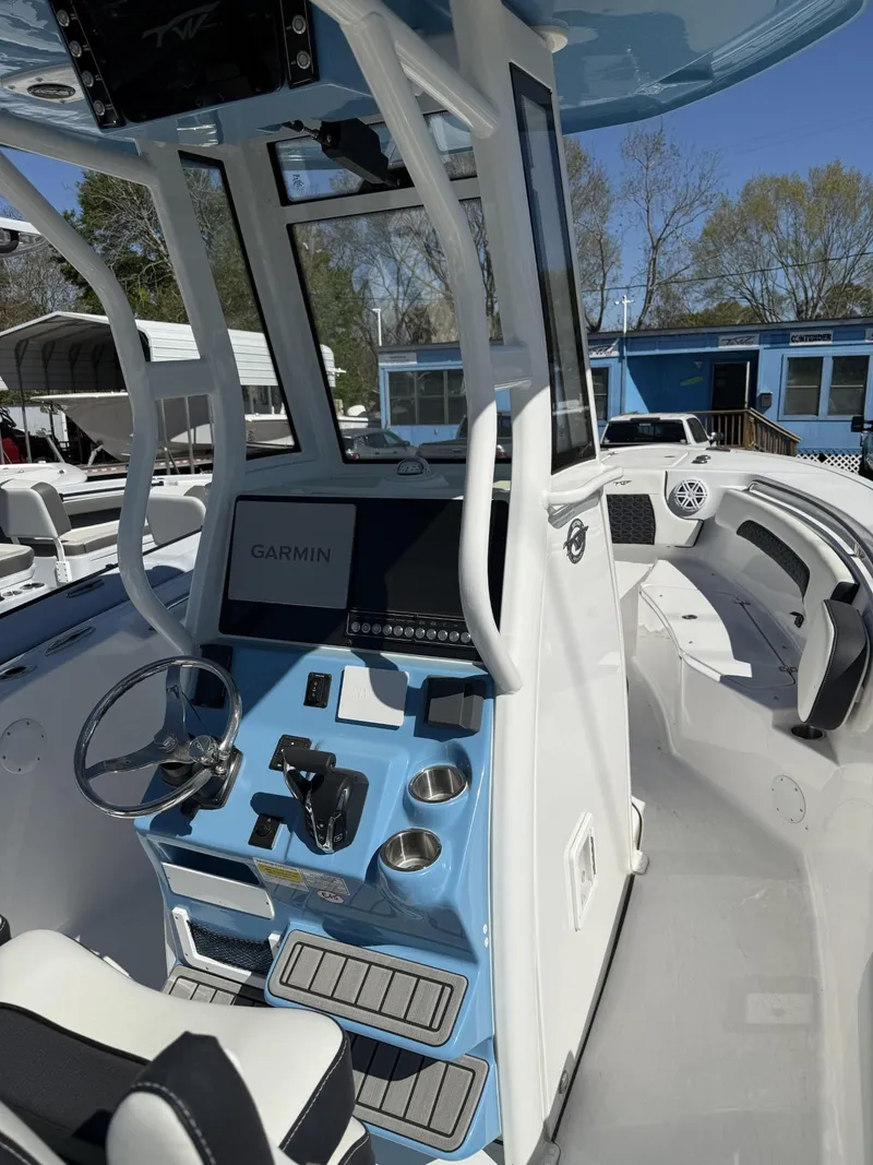 Slide: The Image of 2025 Tidewater 232 CC Adventure boat with modern helm and Garmin navigation system. - 5