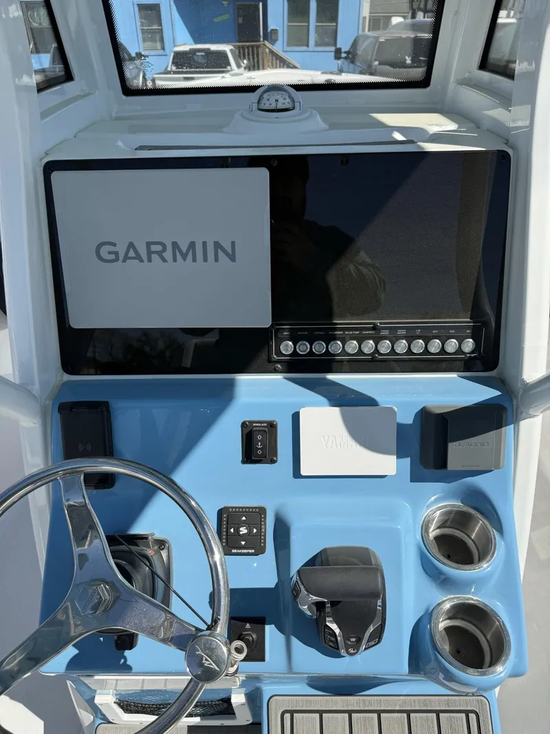 Slide: The Image of 2025 Tidewater 232 CC Adventure boat dashboard with Garmin navigation system and steering wheel. - 9