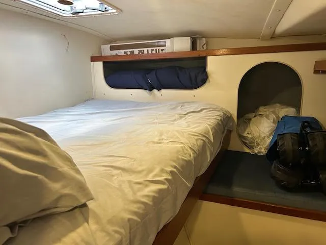 Slide: The Image of Cozy cabin interior of 1995 Lagoon TPI 37 sailboat with bed and storage. - 10