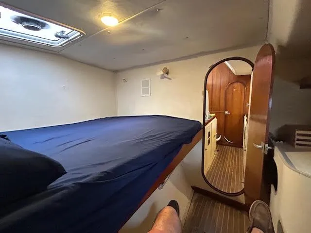 Slide: The Image of Cabin interior of 1995 Lagoon TPI 37 sailboat with bed and wooden flooring. - 12