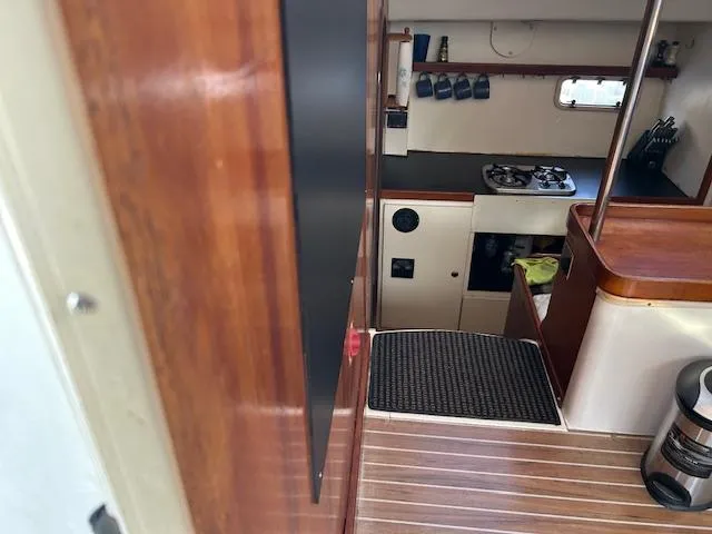 Slide: The Image of Interior of 1995 Lagoon TPI 37 yacht, featuring a compact kitchen area. - 14
