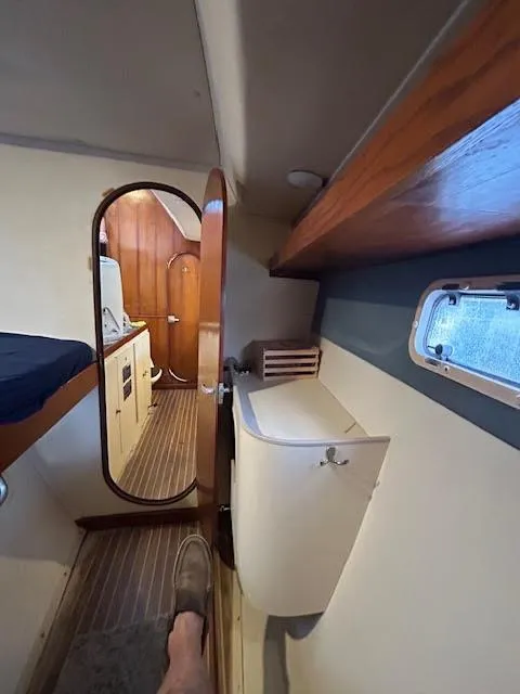 Slide: The Image of Interior of 1995 Lagoon TPI 37 yacht, featuring cozy cabin and wooden accents. - 22