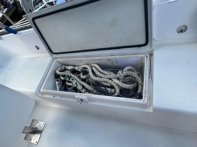 Slide: The Image of Open storage compartment on 1995 Lagoon TPI 37 sailboat with ropes inside. - 23