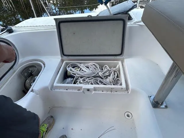 Slide: The Image of Open storage compartment on 1995 Lagoon TPI 37 sailboat, containing coiled ropes. - 25