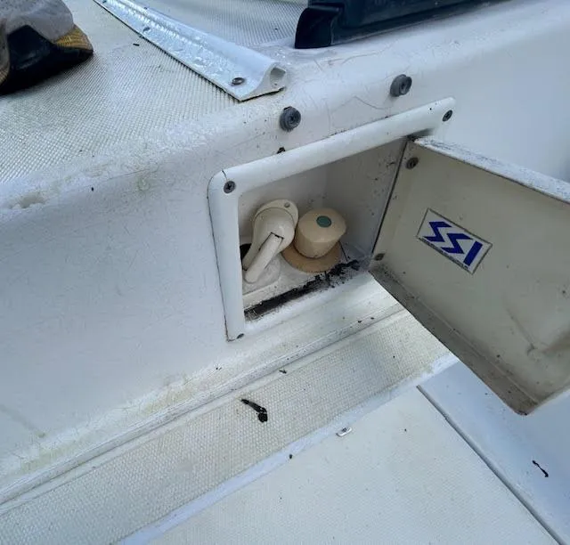 Slide: The Image of 1995 Lagoon TPI 37 boat compartment with open hatch and visible fittings. - 26