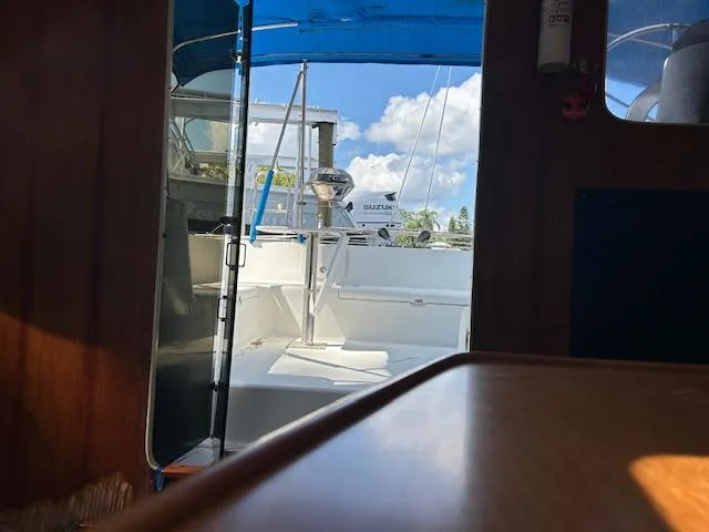 Slide: The Image of Interior view of 1995 Lagoon TPI 37 sailboat with open cockpit and blue canopy. - 28