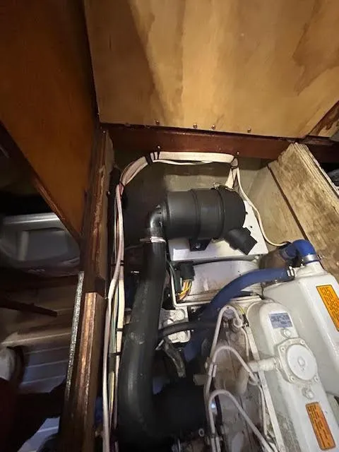 Slide: The Image of Engine compartment of a 1995 Lagoon TPI 37 sailboat, showing hoses and components. - 30