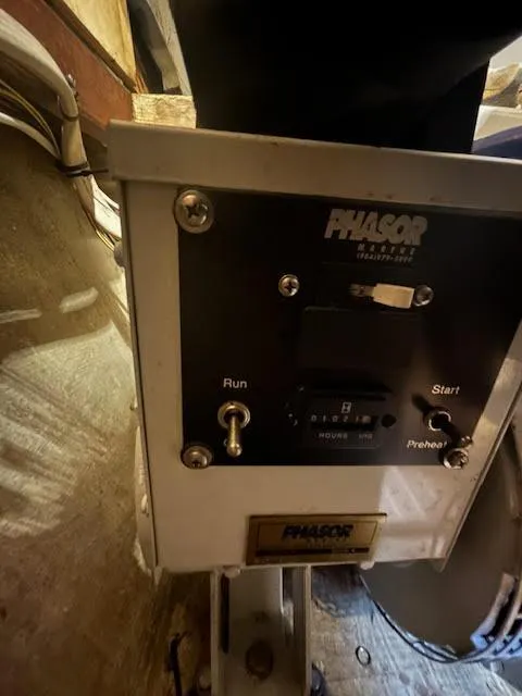 Slide: The Image of Control panel of a 1995 Lagoon TPI 37 boat with Phasor generator switches. - 31