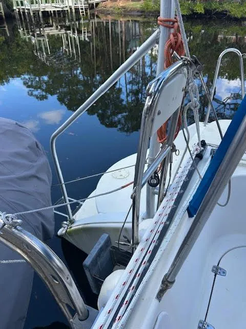 Slide: The Image of 1995 Lagoon TPI 37 sailboat docked by calm water, featuring deck and railing details. - 36