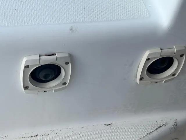 Slide: The Image of Two circular fixtures on a 1995 Lagoon TPI 37 boat surface. - 37