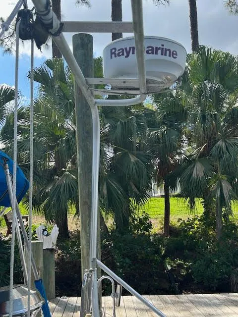 Slide: The Image of Radar equipment on a 1995 Lagoon TPI 37 sailboat, docked near palm trees. - 44