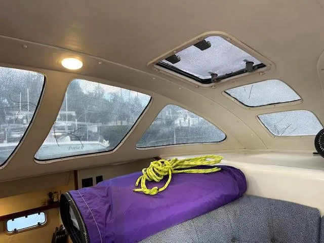 Slide: The Image of Interior of a 1995 Lagoon TPI 37 with purple rope and windows. - 48