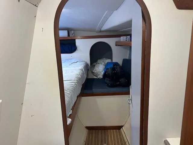 Slide: The Image of Interior cabin of 1995 Lagoon TPI 37 sailboat with bed and storage space. - 9
