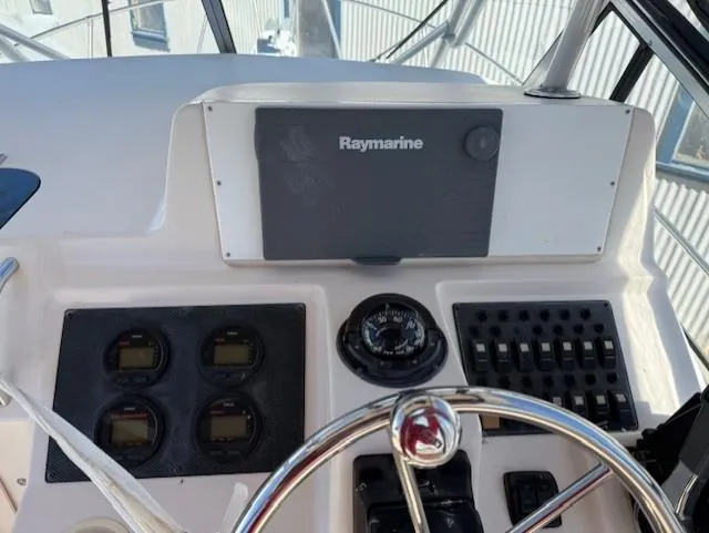 Slide: The Image of Control panel of 2003 Grady-White Sailfish 282 with Raymarine navigation system. - 10