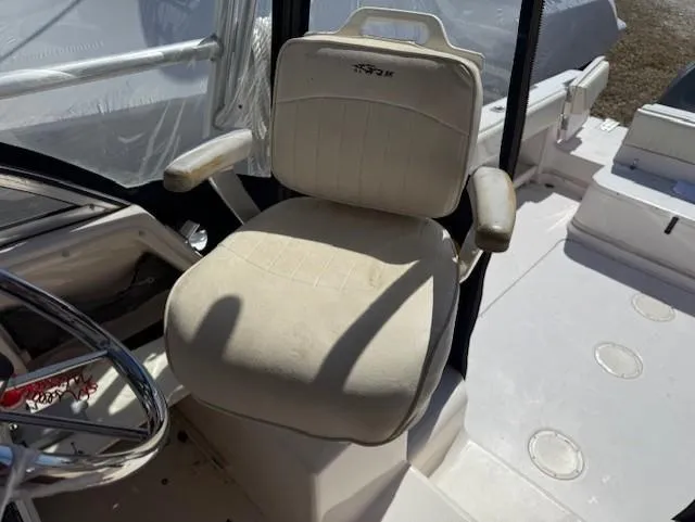 Slide: The Image of Captain's chair on 2003 Grady-White Sailfish 282 boat, featuring comfortable seating and armrests. - 11