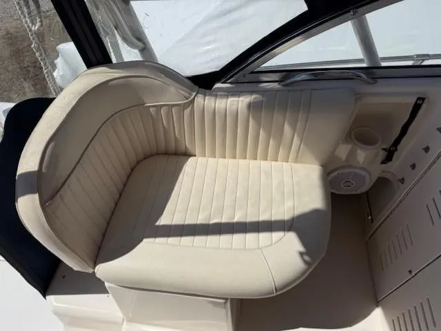 Slide: The Image of 2003 Grady-White Sailfish 282 boat seat, cream upholstery, cup holder, and speaker. - 12
