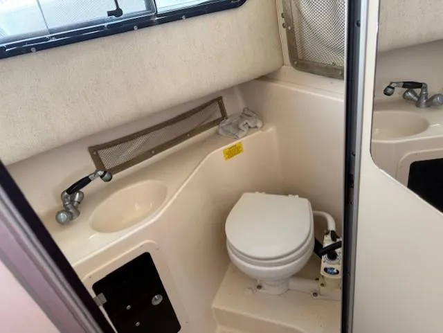 Slide: The Image of 2003 Grady-White Sailfish 282 boat bathroom with toilet and sink. - 18