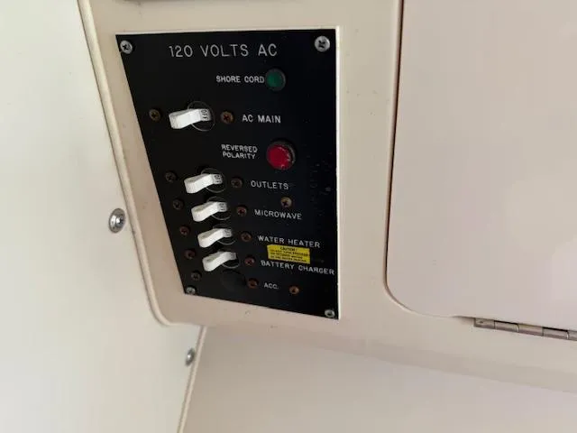 Slide: The Image of Electrical panel on 2003 Grady-White Sailfish 282 boat, showing 120 volts AC controls. - 19