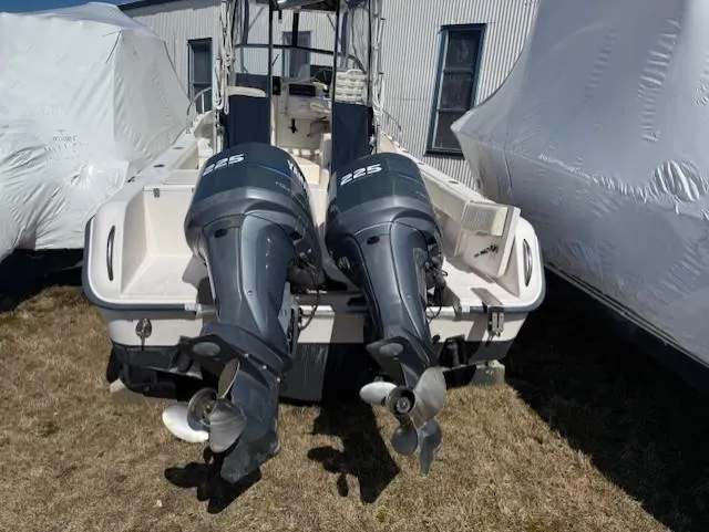 Slide: The Image of 2003 Grady-White Sailfish 282 with twin 225 horsepower outboard motors, docked outdoors. - 2