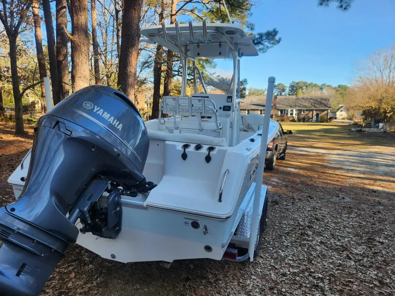 Slide: The Image of 2016 Sea Hunt Ultra 225 boat with Yamaha engine, parked outdoors on a sunny day. - 4