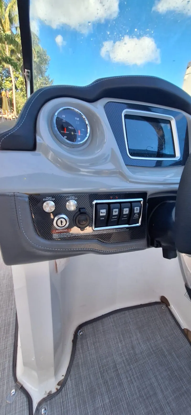 Slide: The Image of 2018 Chaparral Vortex 243 VRX dashboard with controls and display under a blue sky. - 11