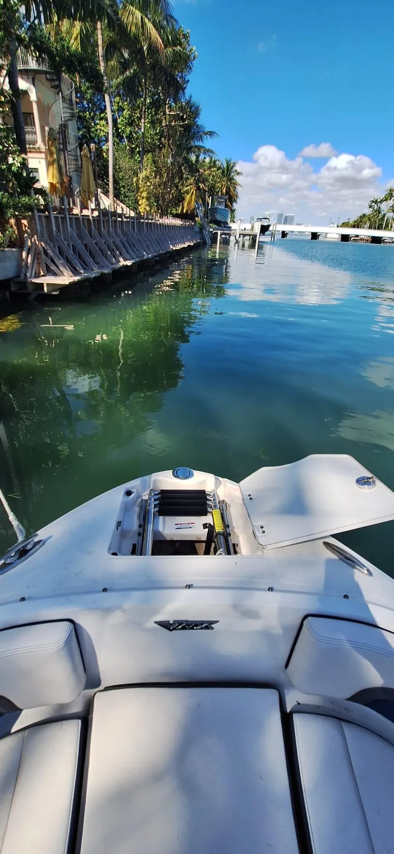 Slide: The Image of 2018 Chaparral Vortex 243 VRX boat on a serene waterway with palm trees. - 13