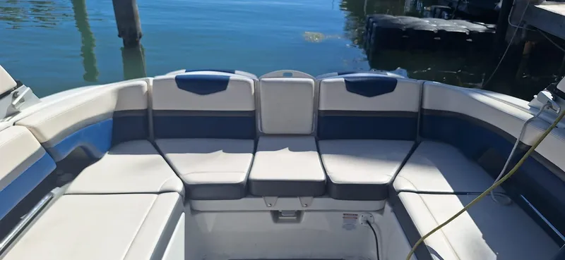 Slide: The Image of 2018 Chaparral Vortex 243 VRX boat interior with cushioned seating by the water. - 17