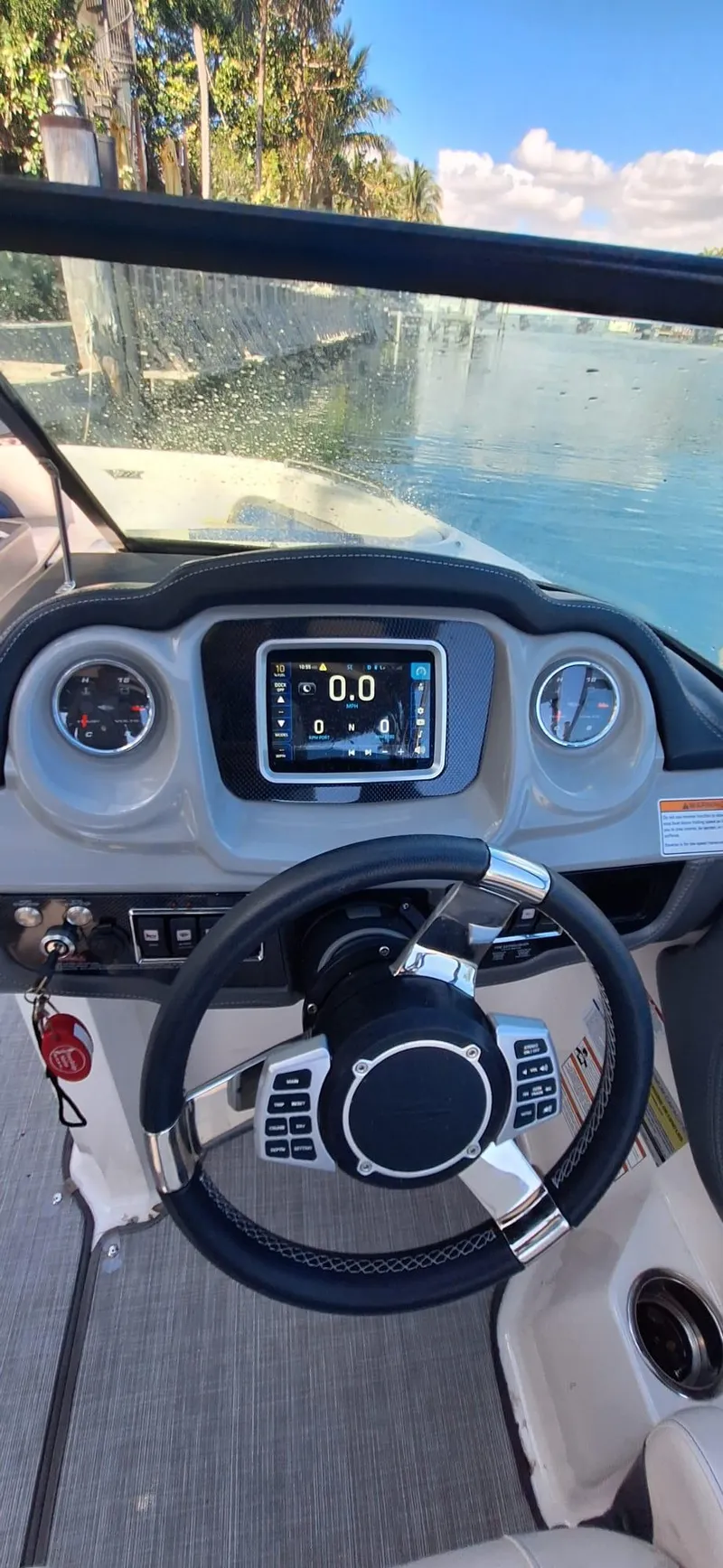 Slide: The Image of 2018 Chaparral Vortex 243 VRX boat dashboard with steering wheel and digital display. - 19