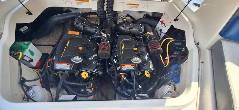 Slide: The Image of Engine compartment of a 2018 Chaparral Vortex 243 VRX boat, showcasing dual engines. - 20