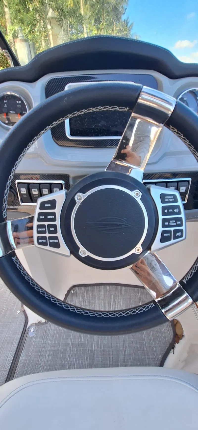 Slide: The Image of Steering wheel of 2018 Chaparral Vortex 243 VRX boat with control buttons. - 9