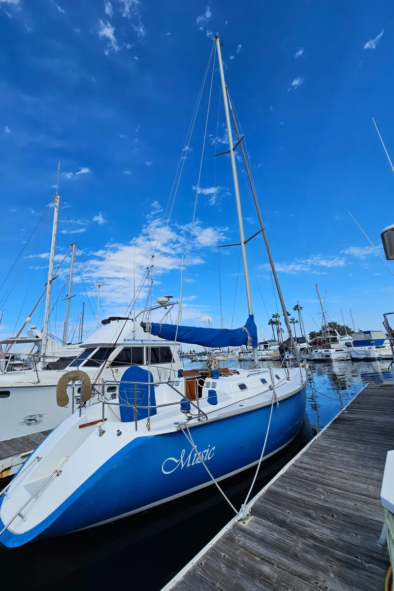Slide: The Image of 1988 Hunter Legend 35 sailboat docked under blue sky. - 2