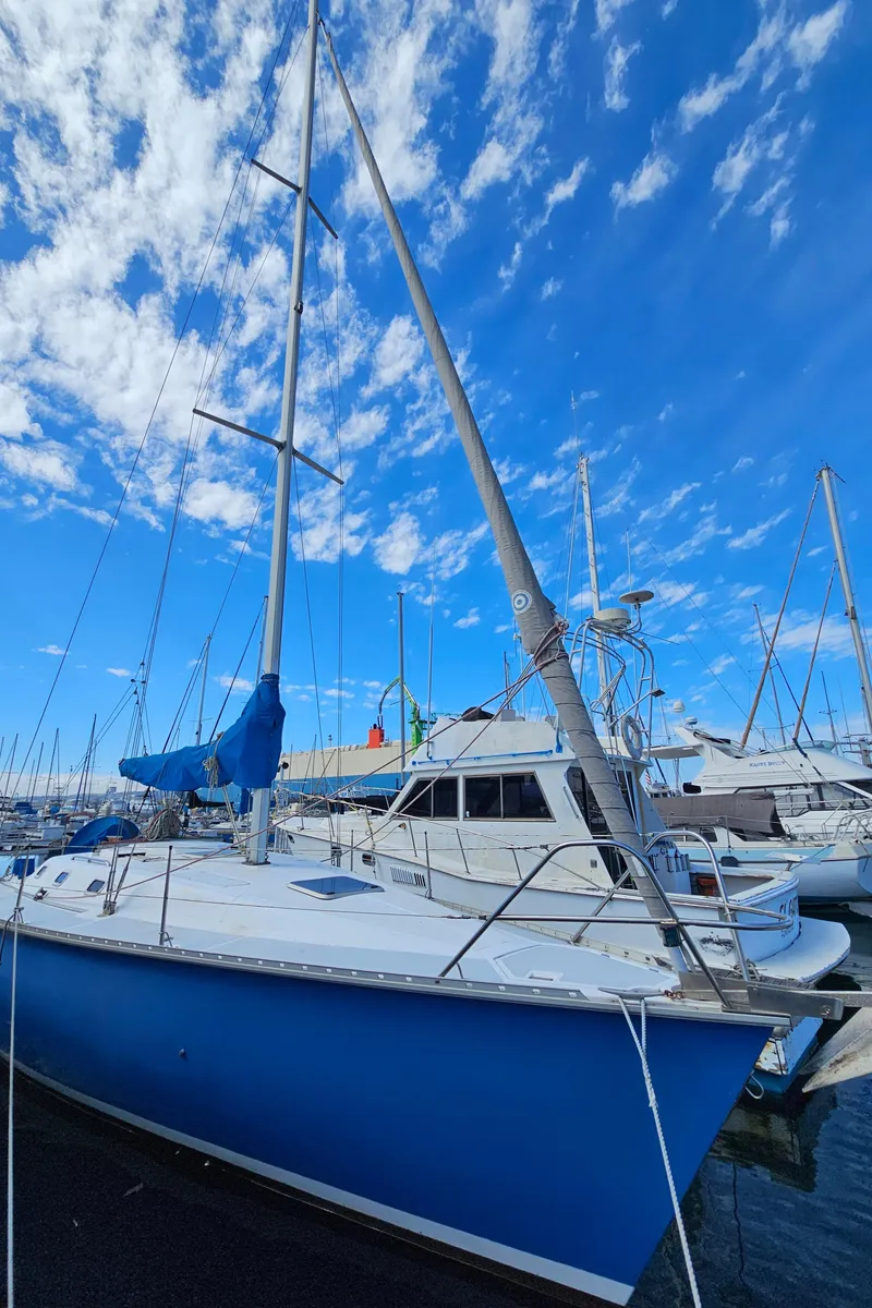 Slide: The Image of 1988 Hunter Legend 35 sailboat docked under a blue sky. - 3