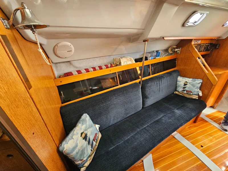 Slide: The Image of Interior of a 1988 Hunter Legend 35 yacht with blue couch. - 32