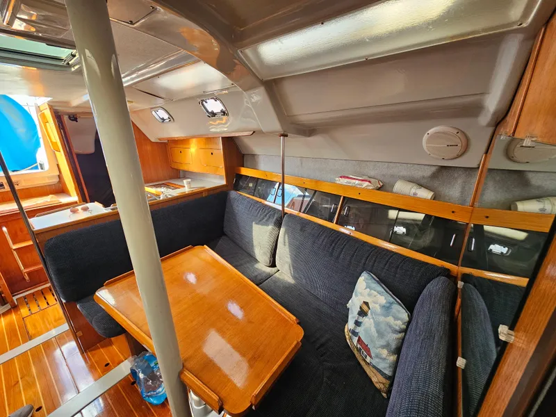 Slide: The Image of Interior of a 1988 Hunter Legend 35 yacht with wooden table and blue upholstery. - 33