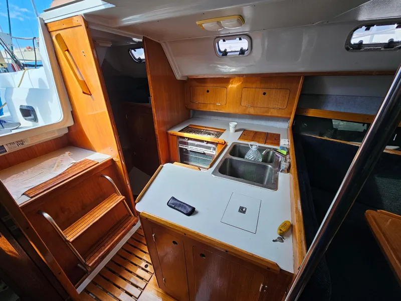 Slide: The Image of Interior of a 1988 Hunter Legend 35 yacht with kitchen and wood paneling. - 39