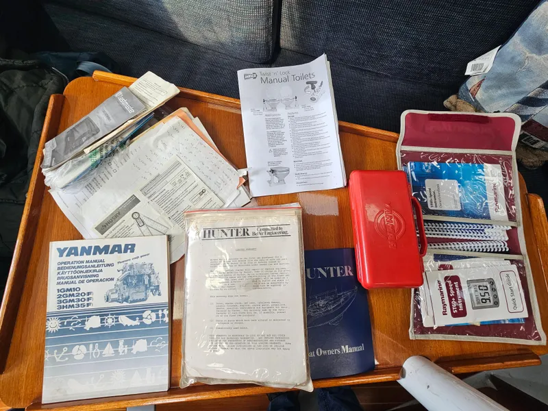 Slide: The Image of Sailboat manuals and accessories on a table, Hunter Legend 35, 1988. - 47