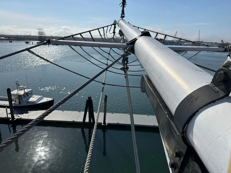 Slide: The Image of View from schooner HARRIS and BISHOP, 2006, showing mast and rigging over calm water. - 12