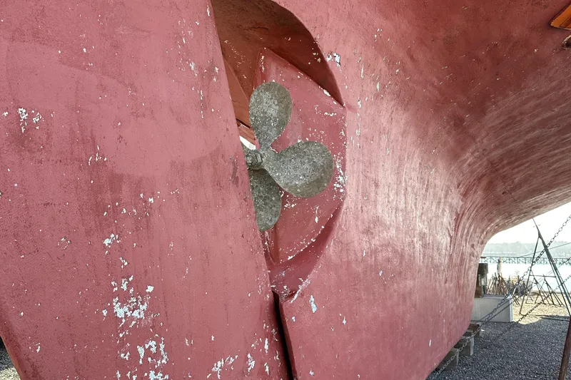 Slide: The Image of Red hull of 2006 Schooner HARRIS and BISHOP with visible propeller. - 13