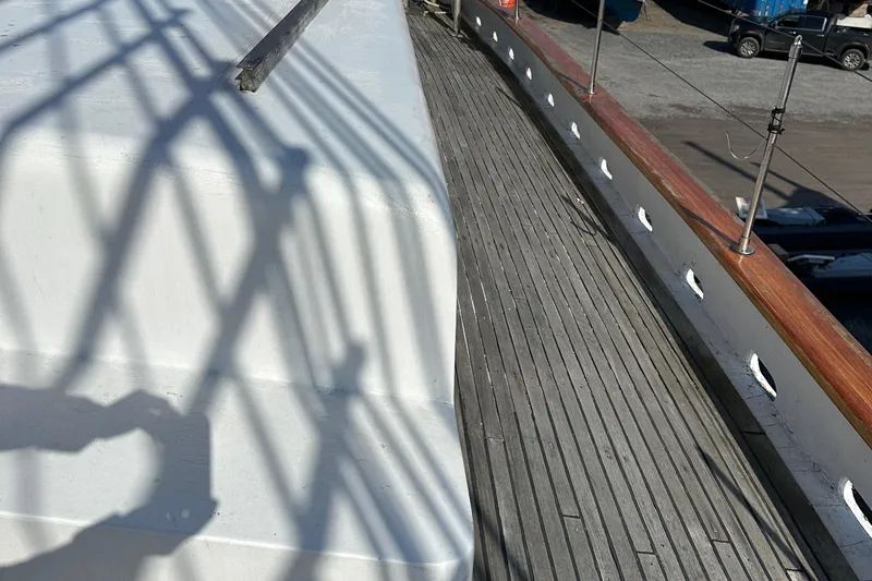 Slide: The Image of Wooden deck of 2006 Schooner HARRIS and BISHOP, featuring sleek design and shadow patterns. - 18
