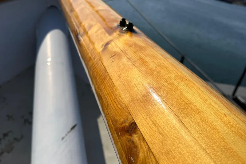 Slide: The Image of Close-up of a polished wooden mast on a 2006 Schooner HARRIS and BISHOP. - 28