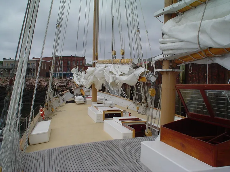 Slide: The Image of Schooner HARRIS and BISHOP 2006 docked, showcasing deck and rigging under cloudy skies. - 33