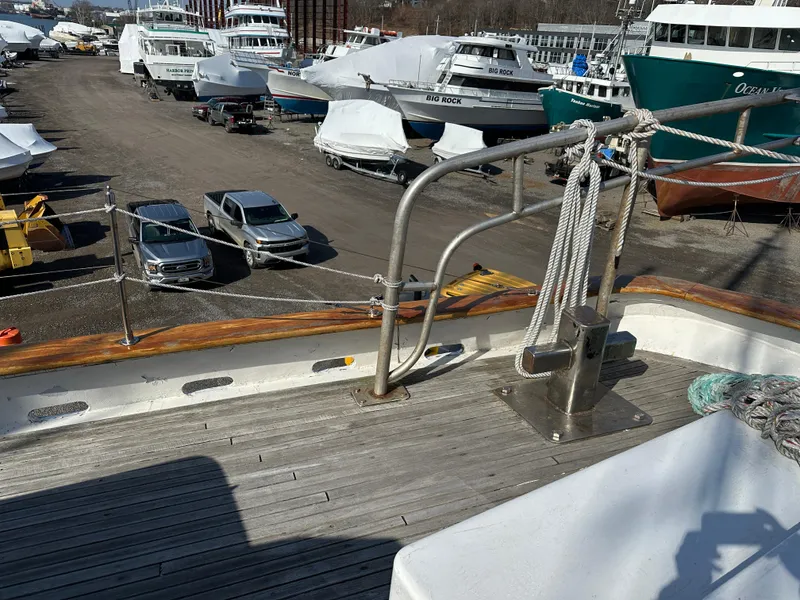 Slide: The Image of Schooner HARRIS and BISHOP 2006 on deck, surrounded by parked boats and cars. - 38