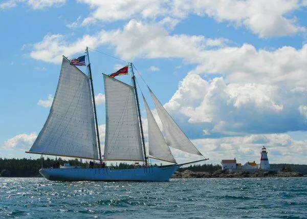 Slide: The Image of Schooner HARRIS and BISHOP sailing near a lighthouse under a cloudy sky, 2006. - 4