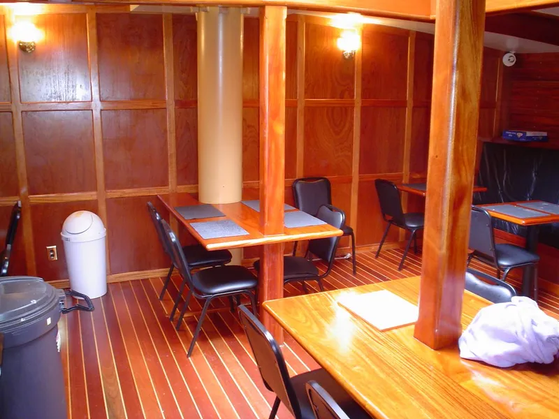 Slide: The Image of Interior of 2006 Schooner HARRIS and BISHOP with wooden tables and chairs. - 44