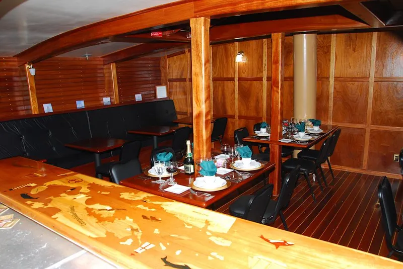 Slide: The Image of Luxurious wooden interior of 2006 Schooner HARRIS and BISHOP, featuring elegant dining setup. - 48