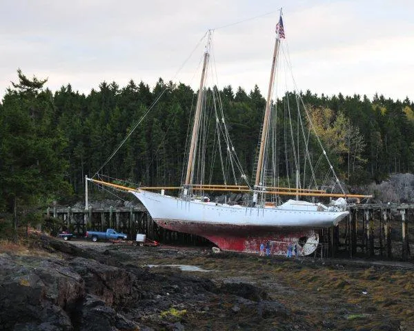 Slide: The Image of Schooner HARRIS and BISHOP 2006 on dry dock, surrounded by forested landscape. - 6