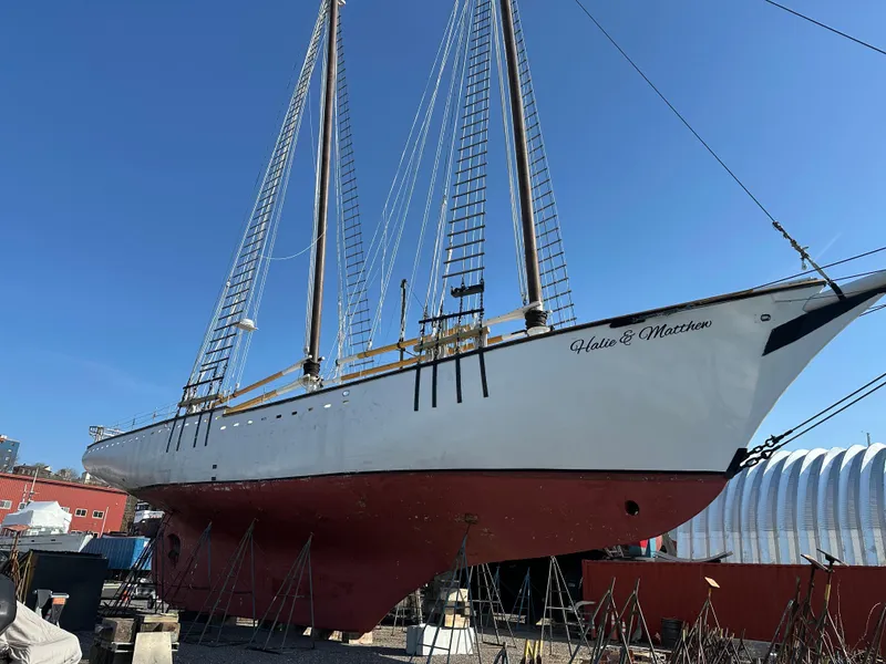 Slide: The Image of Schooner HARRIS and BISHOP 2006 model, dry docked, with red hull and white upper structure. - 7