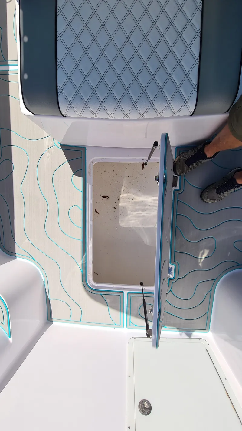 Slide: The Image of 2025 Custom Core 38 Center Console boat interior with open storage compartment. - 11