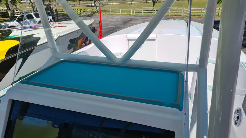 Slide: The Image of 2025 Custom Core 38 Center Console boat with blue dashboard and sleek design. - 18